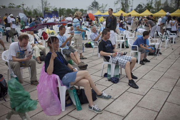 eclipse: Western tourists sit in the rain ahead of the eclipse in Jiaxing, Chin