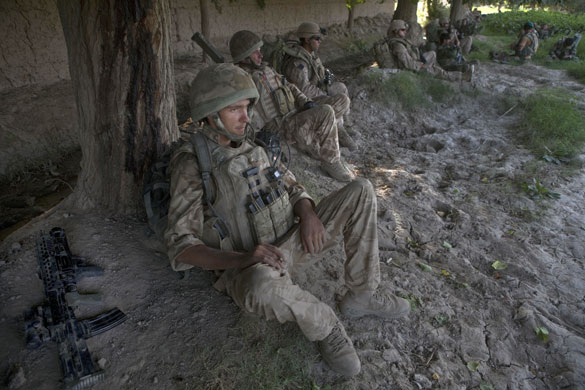 Sean Smith Helmand: A British soldier, part of the mentoring OMLT, smokes while on patrol