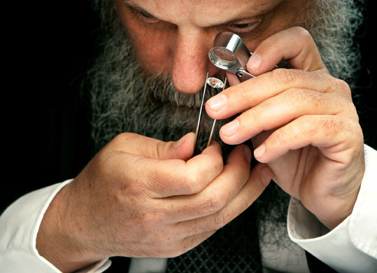 Diamonds: A dealer checks the quality of a diamon