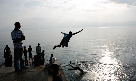 Youngsters dive into the waters of Lake Kivu at Kisegi