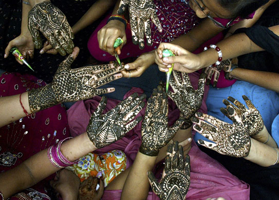 26 July 2009: Amritsar, India: Women show their hands decorated with henna paste