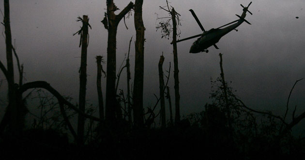 26 July 2009: Cano Cabra, Colombia: An army helicopter flies over a bombarded area