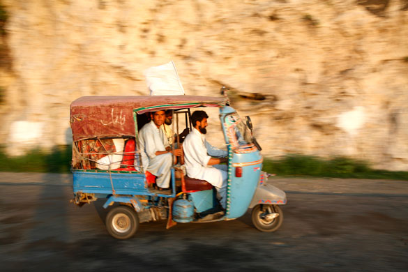 Swat: War-displaced villagers from the Swat valley returning home by rickshaw