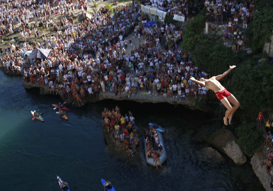 27 July 2009: Mostar Bridge, Bosnia: A diver drops through the air from the Mostar bridge