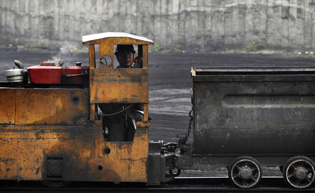 27 July 2009: Changzhi, China: A worker sits in a train at a coal dump site