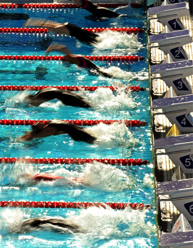 FINA World Championship: The swimmers dive backwards as they start a women's 100m Backstroke heat 