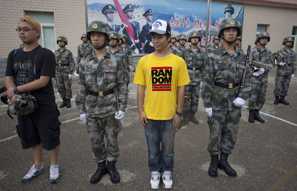 People's Liberation Army: Members of the media pose with People's Liberation Army soldiers