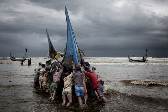 Bangladesh flood defences: After a day of fishing in Bengal Bay, the boats returns to the beach