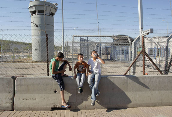 Beach in Israel: Palestinian children pause at the Meitar checkpoint