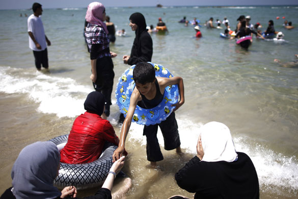 Beach in Israel: A boy wearing a rubber ring
