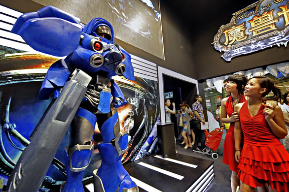 China Digital Expo: Two women look at a character from Blizzard's forthcoming video game