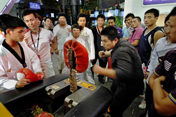 China Digital Expo: A visitor tries an electronic punching machine