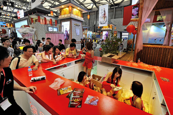 China Digital Expo: Models take a break under a counter