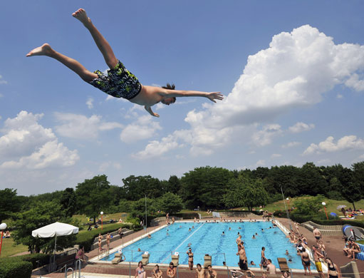 24 hours in pictures: A boy dives into a swimming pool Germany
