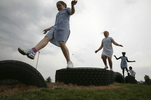 Manchester East 1 - 10: Schoolgirls outside enjoy running over tyres