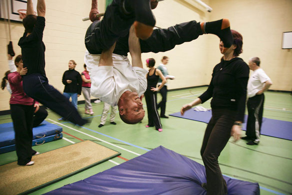 Manchester East 1 - 10: A man is captured upside down as he summersaults in a gymnasium