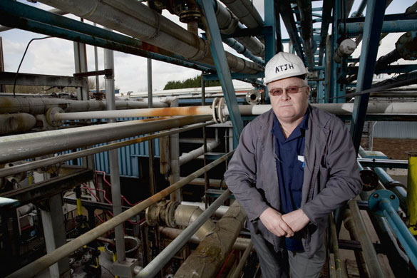 Manchester East 1 - 10: A man stands amongst factory pipework in a hard hat