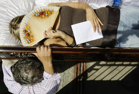 24 hours in pictures: Penitents carry a coffin at Procession of the Shrouds in Spain 