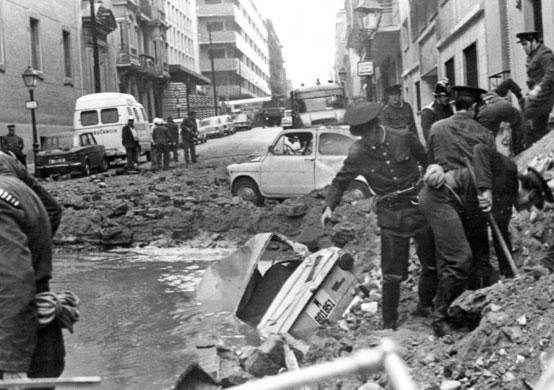 History of ETA: 1973: Spanish policemen search among the damage after a bomb attack