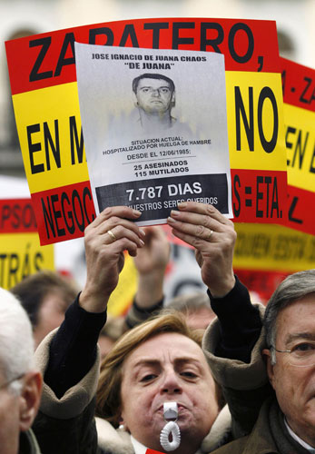 History of ETA: 2006: A woman holds a picture of a member of ETA during a demonstration