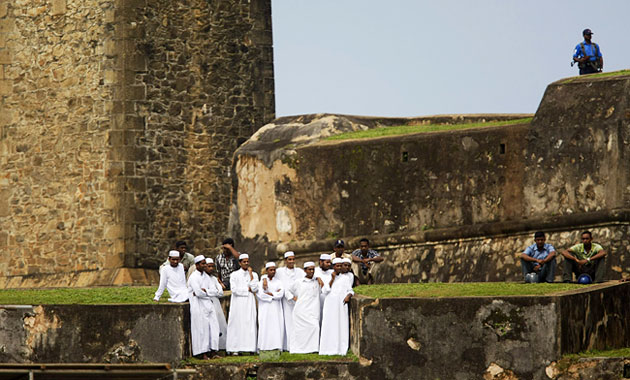 24 hours in sport: men watch cricket match between from the ramparts of Galle Fort