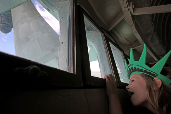 24 hours in pictures: New York City, USA: A girl in the crown of the Statue of Liberty