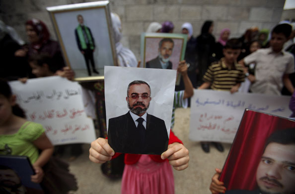 24 hours in pictures: Ramallah, West Bank: Relatives of Palestinian Hamas lawmakers protest