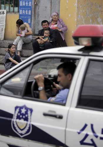 Urumqi riots: Security forces during a clampdown after yesterday's disturbances