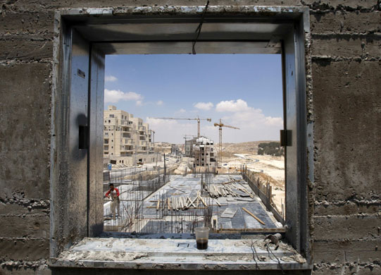 24 hours in pictures: A Palestinian labourer at a construction site near Jerusalem