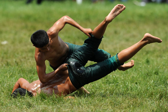 24 hours in pictures: Turkish oil wrestlers compete during the Kirkpinar oilwrestling tournament 