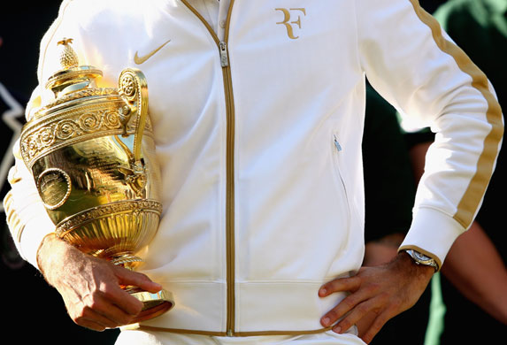 24 hours in pictures: Wimbledon 2009 Roger Federer celebrates with the trophy