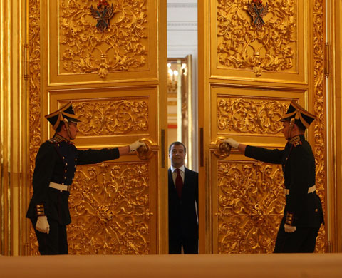 Obama in Russia: Russian President Dmitry Medvedev stands as doors are opened by guards