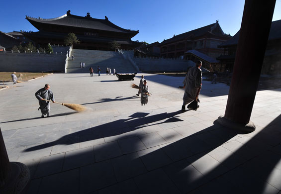 24 hours in pictures: Chinese Buddhists perform their morning chores at Wutaishan