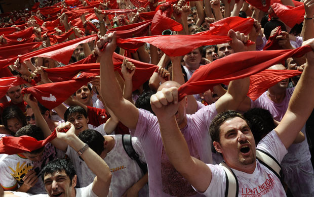 24 hours in pictures: Revelers hold up red neckties during the 'Chupinazo' in Pamplona