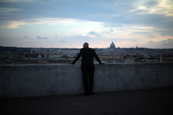 24 hours in pictures: A man looks across the city as the sun rises over the Villa Medici