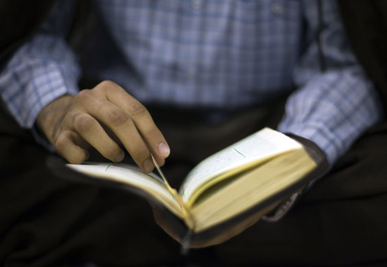 24 hours in pictures: An Iranian Shiite Muslim prays during a ceremony at a mosque in Tehran