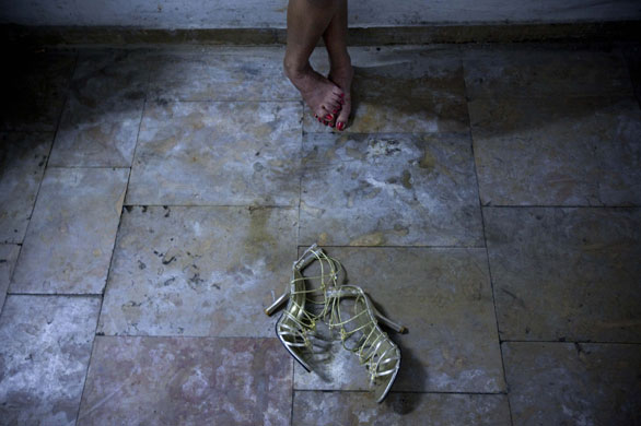 24 hours in pictures: A migrant worker rests during beauty contest auditions