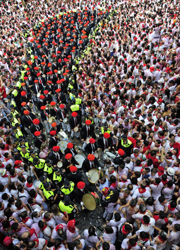 24 hours in pictures: Pamplona music band wearing red berets march through the crowd