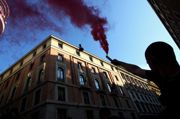 G8 preparations: A protester holds a firework during a demonstration in Rome
