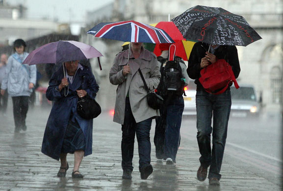 weather london: People walk through wind and rain