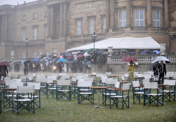 weather london: Guests head for cover at Royal Garden Party at Buckingham Palace