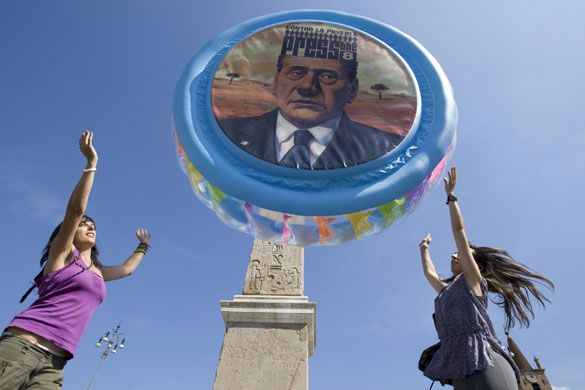 G8 preparations: ActionAid activists throw a pool with Berlusconi's face into the air
