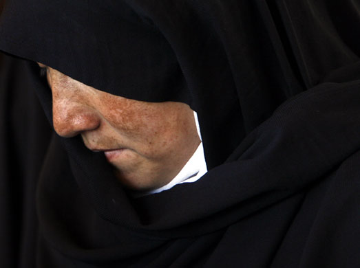 24 hours in pictures: An Afghan woman attends a gathering