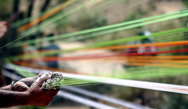 24 hours in pictures: Workers make kite threads