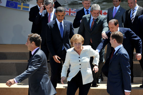 Week in business: Government leaders pose for a group photo during the G8 summit in L'Aquila