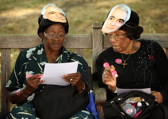 Week in business: Two women wearing Alistair Darling masks play a game of bingo