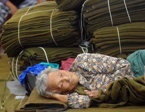 Typhoon Morakot: Chiatung, Taiwan: A woman rests in a temporary evacuation centre