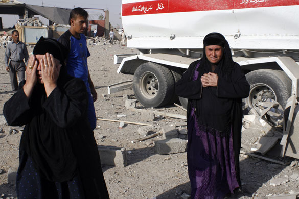 Iraq bombings: Women gather at the site of two truck bombs