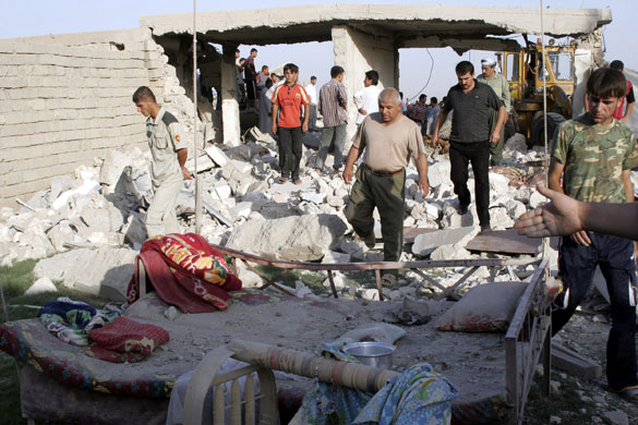 Iraq bombings: People gather at the scene of the double truck attack