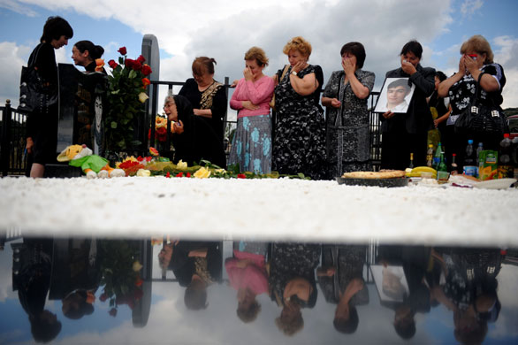 10 August 2009: Tskhinvali, South Ossetia: Women visit the grave of a relative